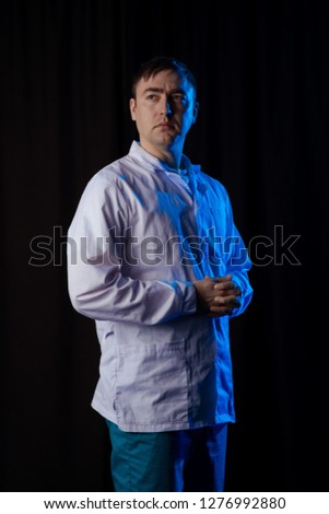 Male Actor without emotion in blue theatrical light