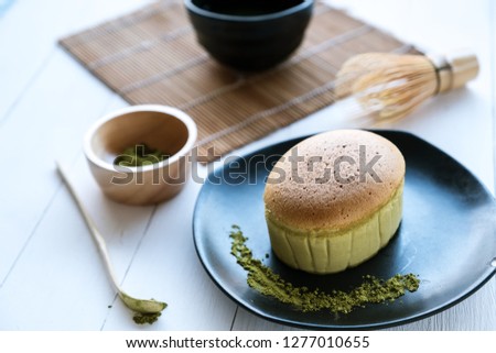 Matcha Japanese cheesecake and matcha green tea on White desk table in morning, Close up.