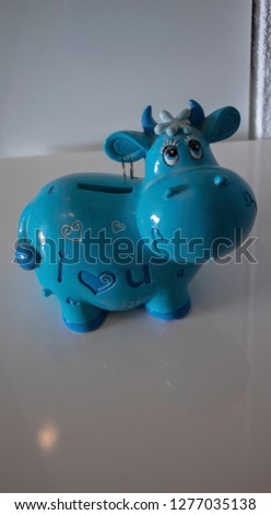 Piggy bank in the shape of a blue cow, cut out object
