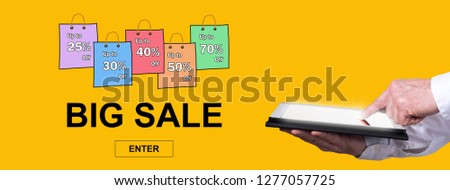 Finger pointing on digital tablet with big sale concept on background