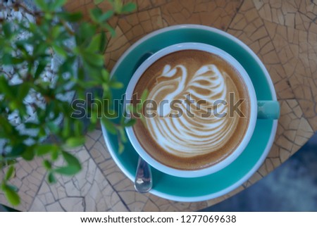 Barista made swan pattern by milk foam on the top of coffee ,latte art