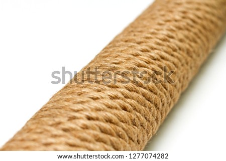 sisal rope cat scratching post on white background. Selective focus, macro close-up