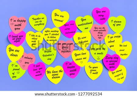 Abstract empty sticky note in the shape of a heart magnet on blue board. Valentine greeting card message.Happy Valentine's day concept. Flat lay. Top view. Mock up. Copy space 