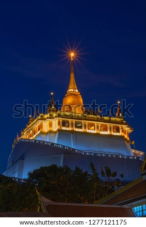 Low angle view(Night time) of Golden Mountain at Wat Saket Ratcha Wora Maha Wihan, Bangkok, Thailand.