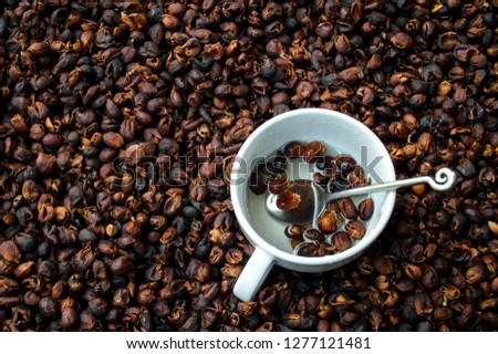 Coffee cherry tea made from the dried skins of dried berries of the coffee plant Cascara in a white cup, Selective focus. Royalty-Free Stock Photo #1277121481