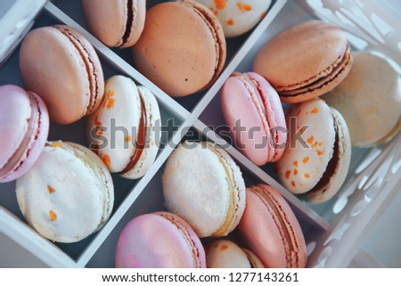 Colorful French dessert macarons. Dessert macaroons. macaroons in white wooden box.