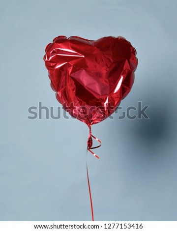 Party is over deflated red heart balloon object for birthday party or love valentines day on light blue background Royalty-Free Stock Photo #1277153416