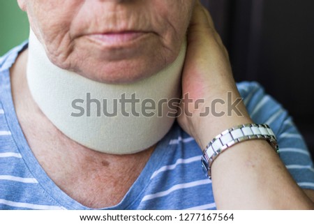 Senior woman wearing neck brace 