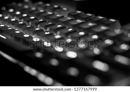 Closeup shot of keyboard illumination, backlit keyboard in black and white
