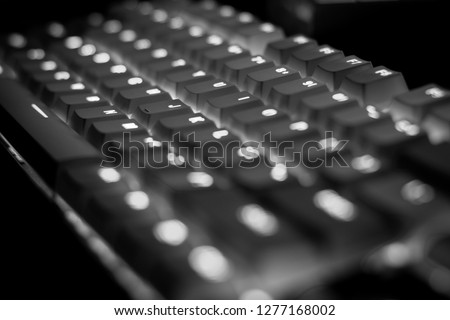 Closeup shot of keyboard illumination, backlit keyboard in black and white
