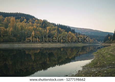 Dark colorful autumn mountain lake in the evening.