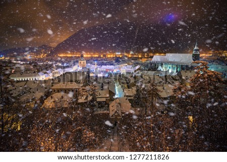 Christmas Tree in the old city center of Brasov in a snowing night,Panoramic view of the old town and  Council Square