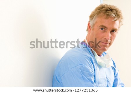 Portrait of male surgeon wearing scrubs in hospital operating room