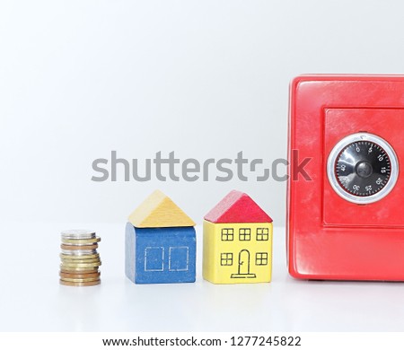 Miniature toy block houses with money box representing property purchase with white background no people stock image and stock photo