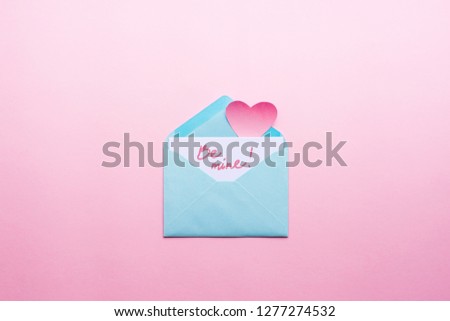 Message Be mine Blue letter with pink heart cartoon style from paper on cardboard background. Valentine day minimal concept Flat lay Top view