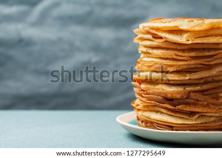 Staple of yeast pancakes, traditional for Russian pancake week (Shrove tide) Royalty-Free Stock Photo #1277295649