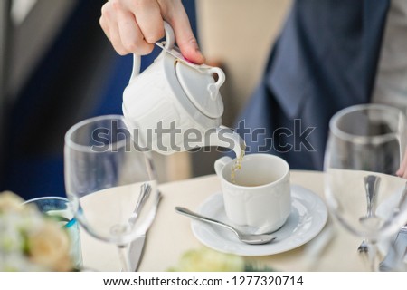 the bride and groom drink coffee in a cafe