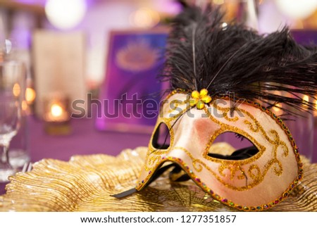 Carnaval table with venetian mask on the plate.