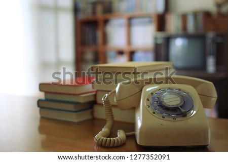Close-up pictures of antique phones on the table in the library stack the book into the background selective focus and shallow depth of field