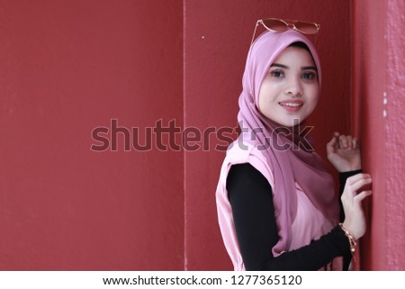 Beautiful face. Cute women wearing hijab. Confident looking women. Business women fashion style inspiration. Dark red background.