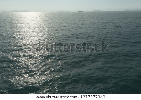 Blue sunny sea water surface with Ferryboat. 