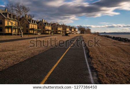 Road passing through an old abandoned houses at Highlands, New Jersey. Shot using slow shutter speed