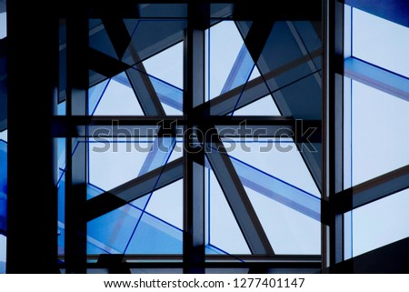 Collage photo of office building fragments in shadows against clear blue sky. Glass wall with metal framework. Structural glazing. Abstract modern architecture background.