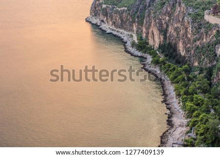 sea cape rock narrow coast line beach in aerial photography scenic landscape in sunset evening time background wallpaper pattern concept with empty space for copy or your text 