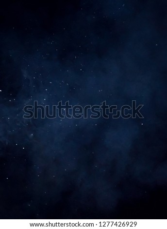 A digitally manipulated cloudy sky textured overlay/starry night wallpaper or background design.
