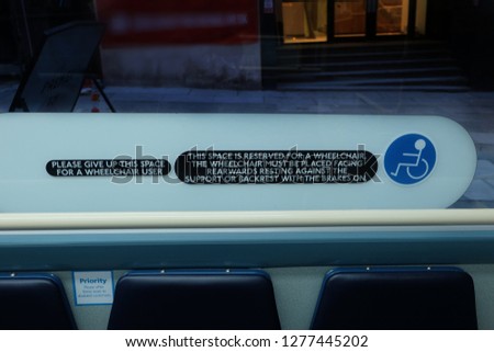 A picture of wheelchair space sign in a bus at Liverpool. 