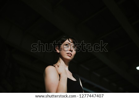 Beautiful woman standing in the dark alley
