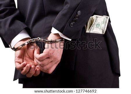 arrested businessman holding hundred dollar bills isolated on a white background Royalty-Free Stock Photo #127746692