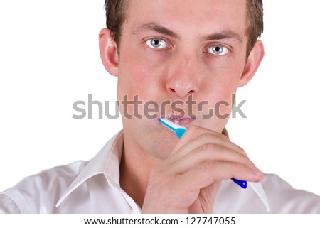 adult male brushing his teeth isolated on a white background, closeup picture