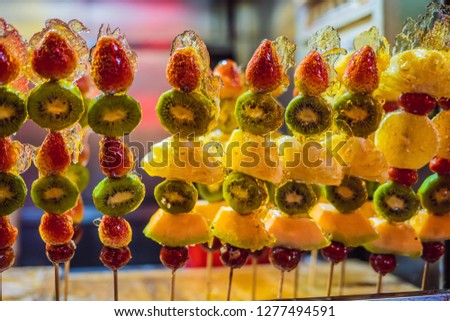 Traditional Chinese Dessert - Candied Fruit on a Wooden Stick