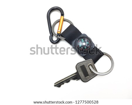 Key with  compass key holder or key chain on white background.