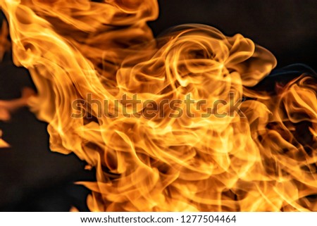 Fire flames on black background, abstract blaze.