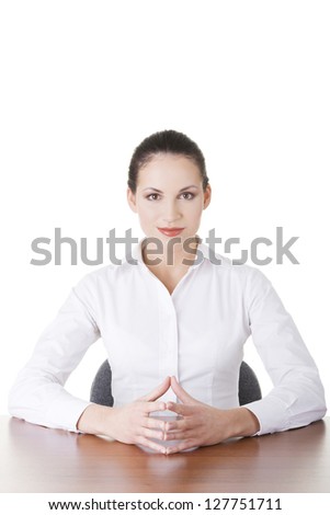 Young beautiful happy businesswoman behind the desk, isolated
