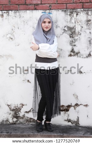 Full body portrait shot of hijab girl. Cute modest fashion inspiration. Asian beauty.