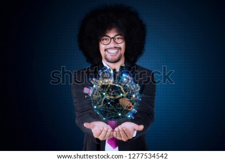 Picture of male manager holding a modern city with connection networking. Shot with virtual screen