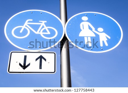 road signs at a sidewalk