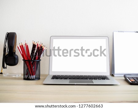 Work desk in home,laptop with stationaries items on desk,selective focus.