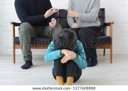 Child depressed by quarrel between mother and father Royalty-Free Stock Photo #1277608888