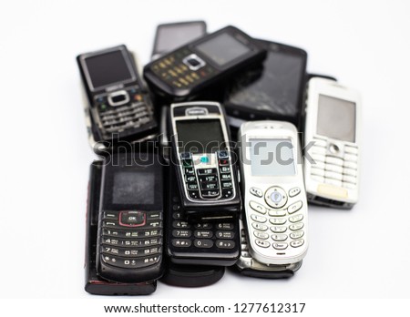 bunch of old cell phones mobile communication retro broken white button tube Royalty-Free Stock Photo #1277612317