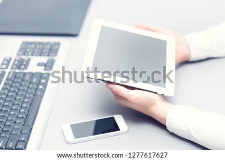 Tablet in hands with shallow depth of field. Office work.