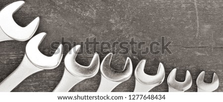 Ring spanners on wooden surface. Top view with copy space.