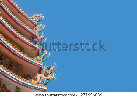 chinease temple roof decorrated dragon with blue sky blackground