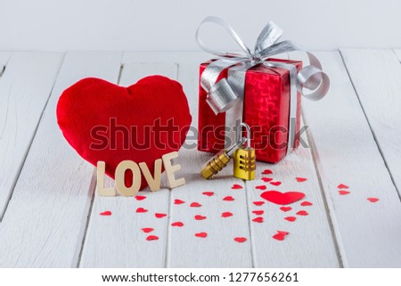 Valentines Day background with Red Gift box, Heart shape, Wooden letters word "LOVE" and Couple Combination golden padlock on white wooden table and copy space for your graphic.