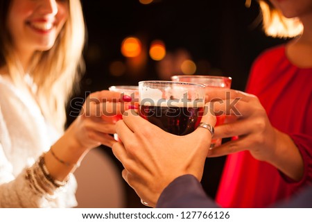 Friends having a round of drinks in a pub Royalty-Free Stock Photo #127766126