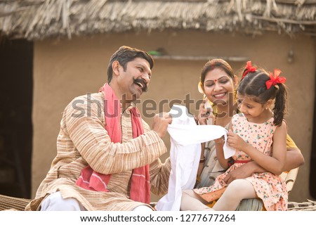 Farmer gifting new dress to little daughter