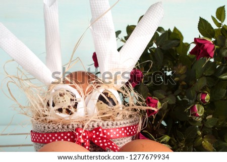 Happy Easter. Easter decorative eggs in a basket on a wooden table .. Easter background.